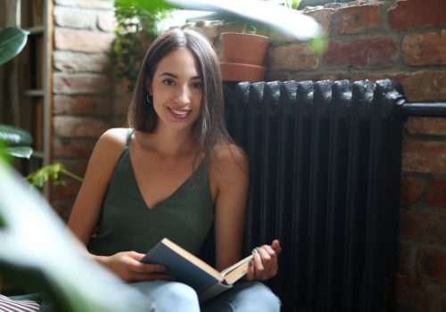 Student. Woman with book on the floor